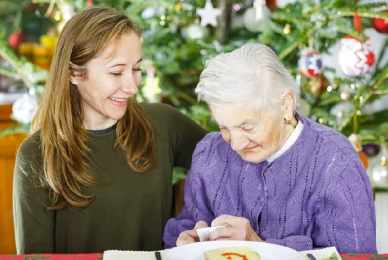 A tender Christmas moment as a young woman gives a thoughtful gift to an elderly lady in hospice care.